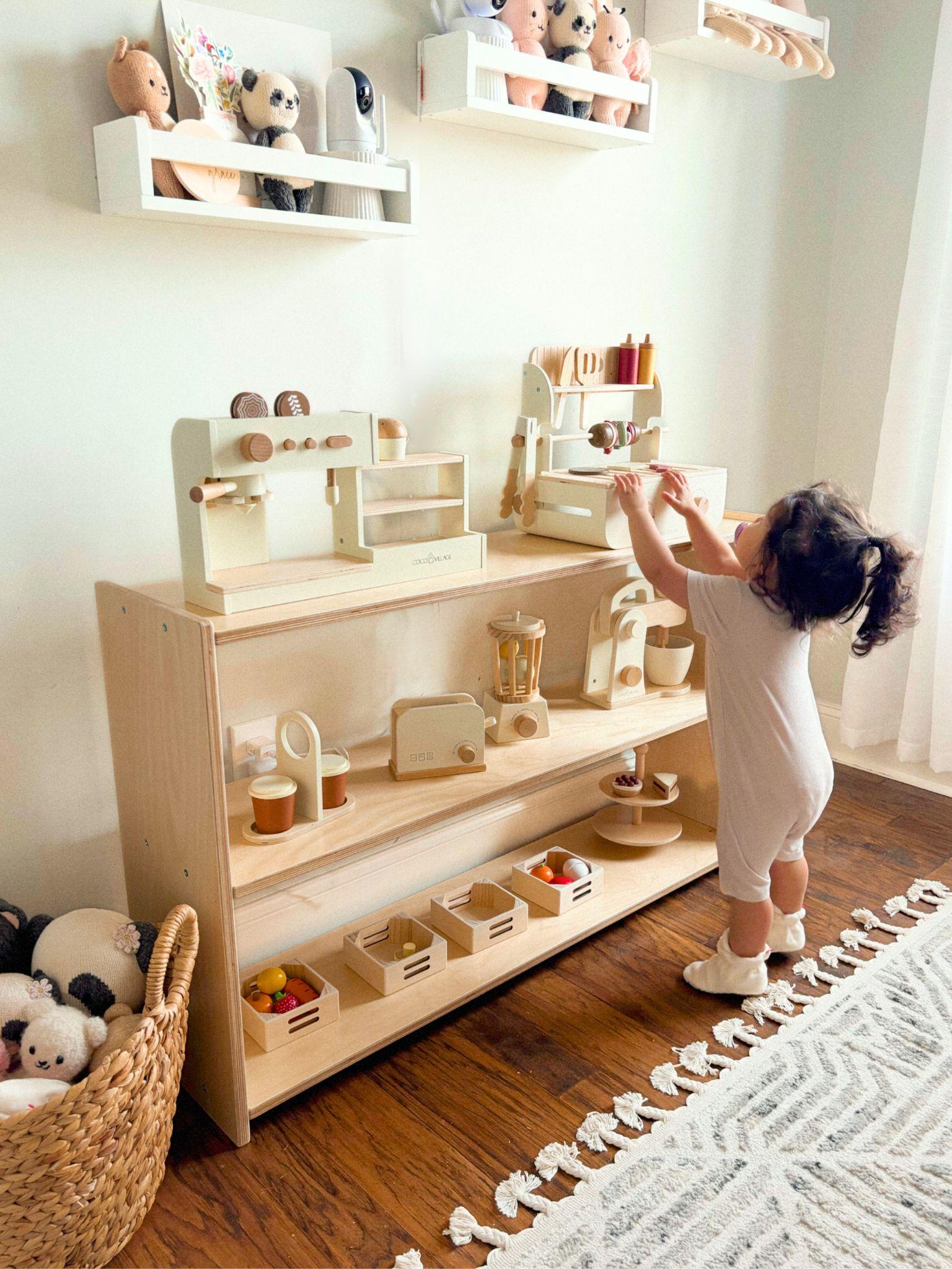 Child playing with educational toys on a wooden shelf in a room with white walls and a rug.