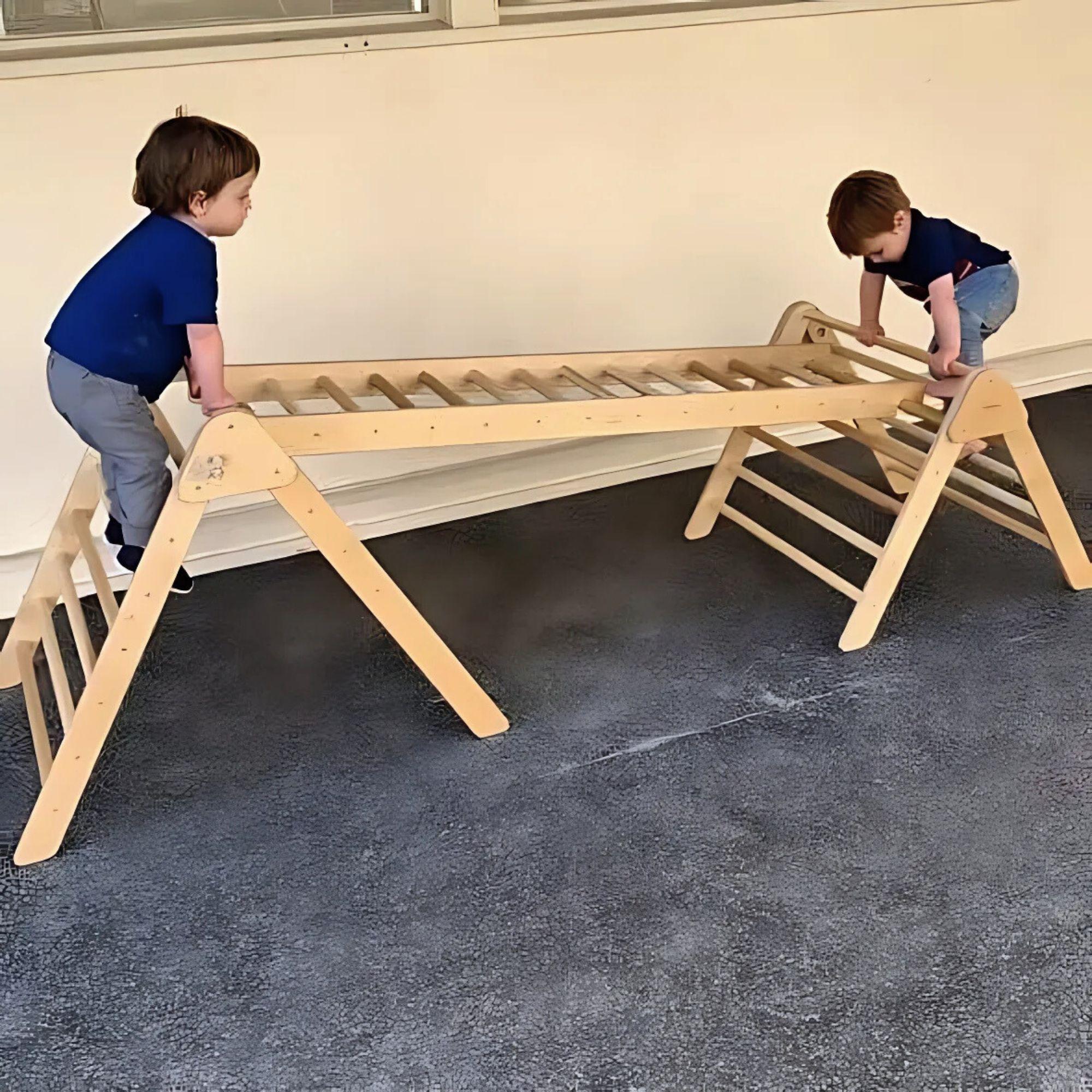 Two children playing on a wooden climbing structure indoors.