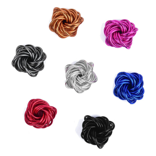 Colorful metal fidget knot toys assorted on white background.