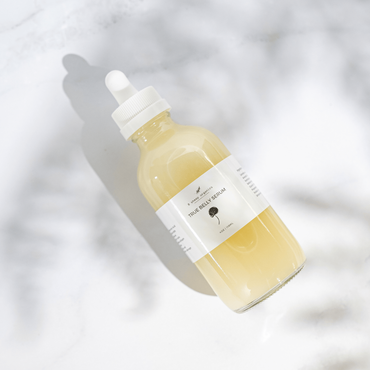 Skincare serum bottle with dropper on a light background