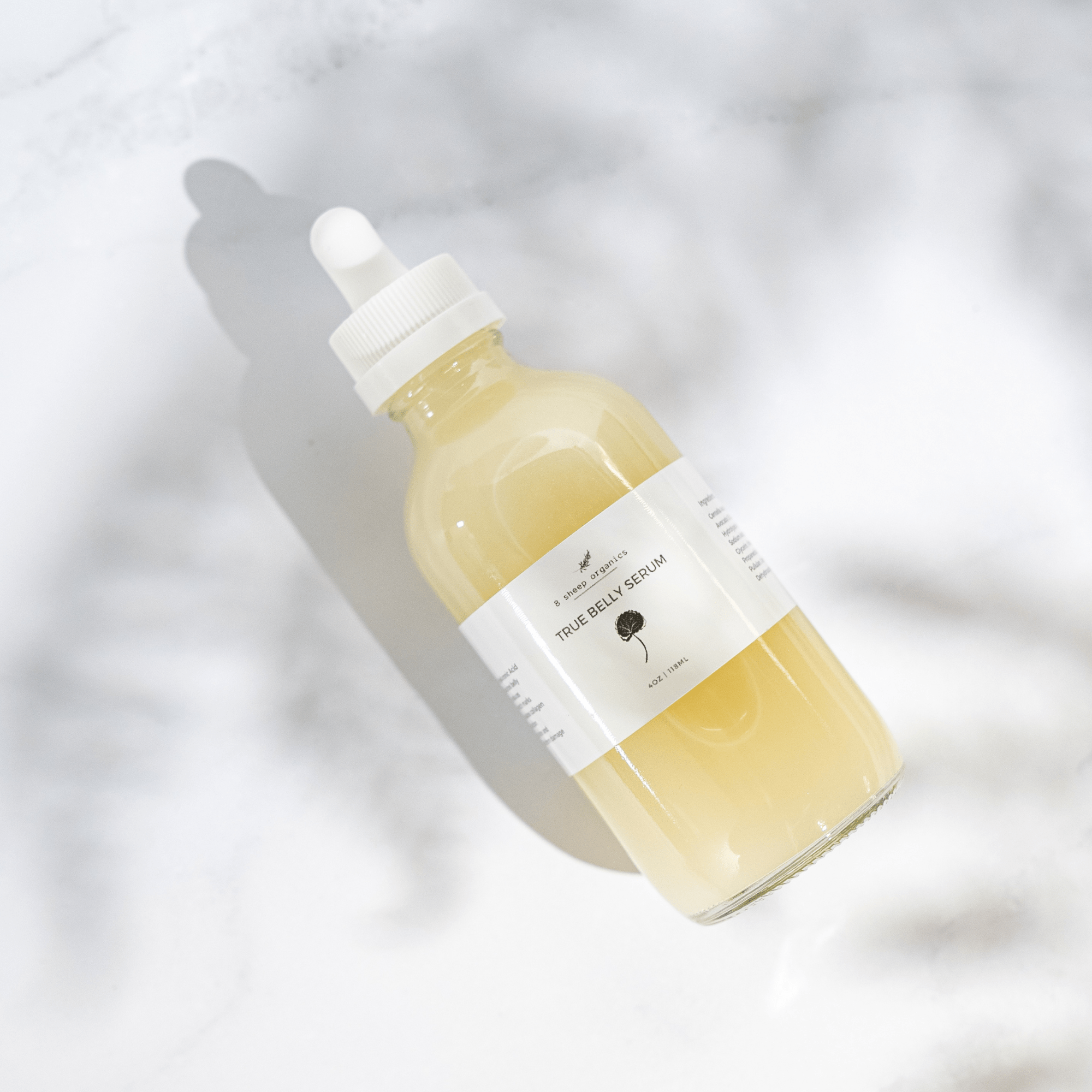 Skincare serum bottle with dropper on a light background