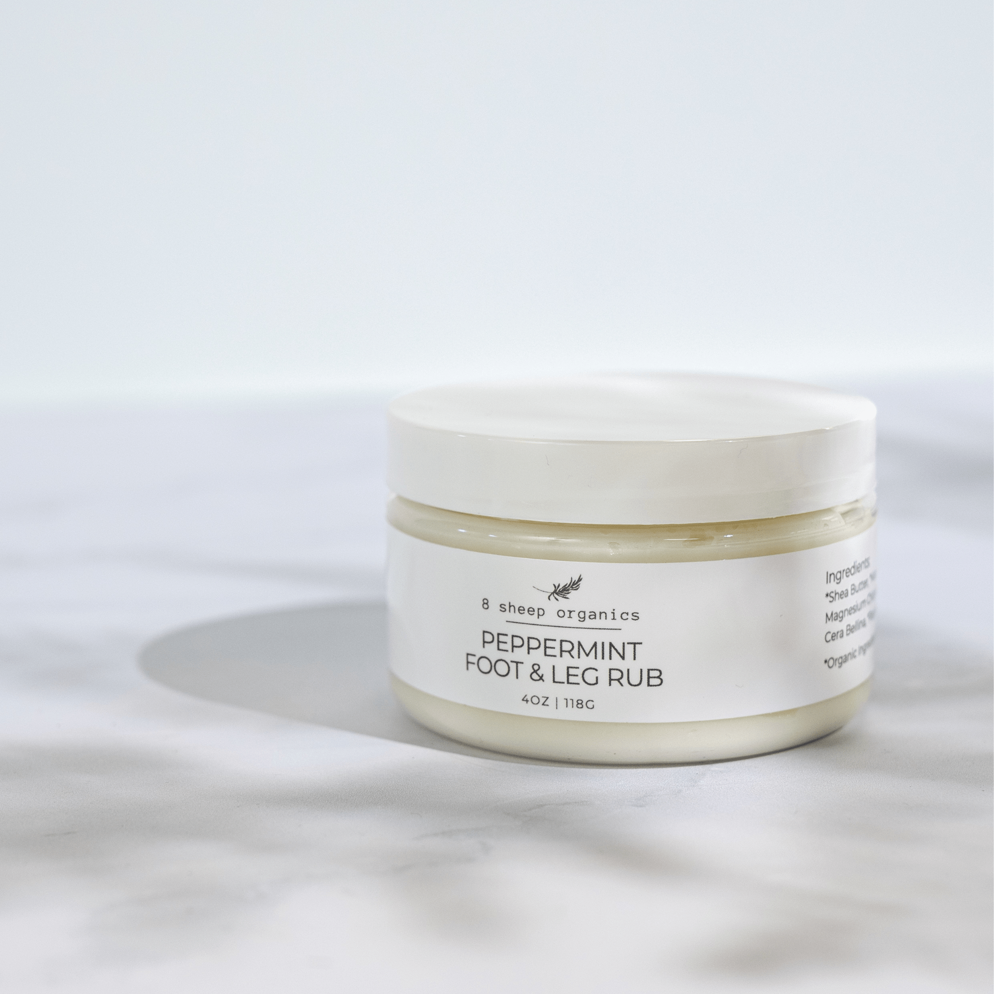 Jar of peppermint foot and leg rub on a white background