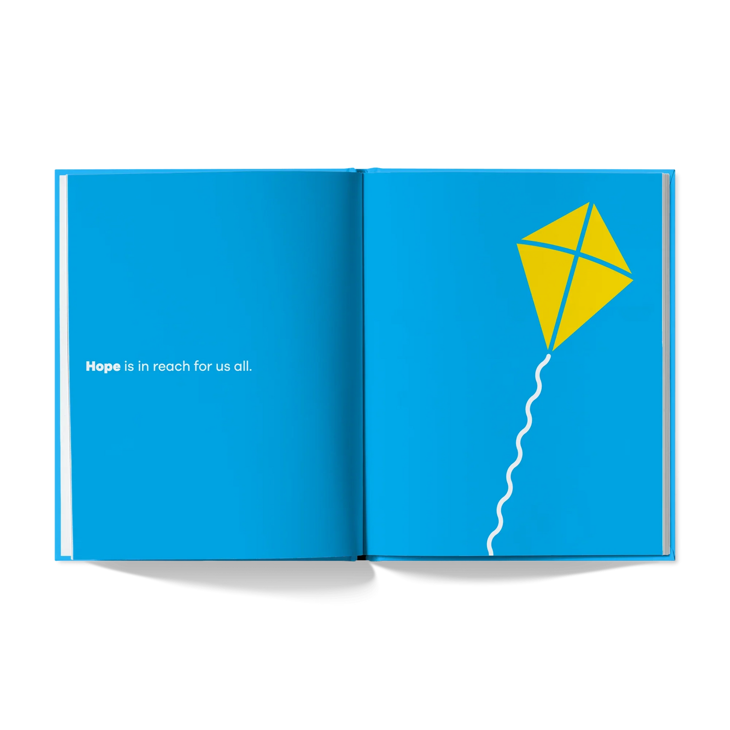 Open book with 'Hope is in reach for us all' text and yellow kite on blue background