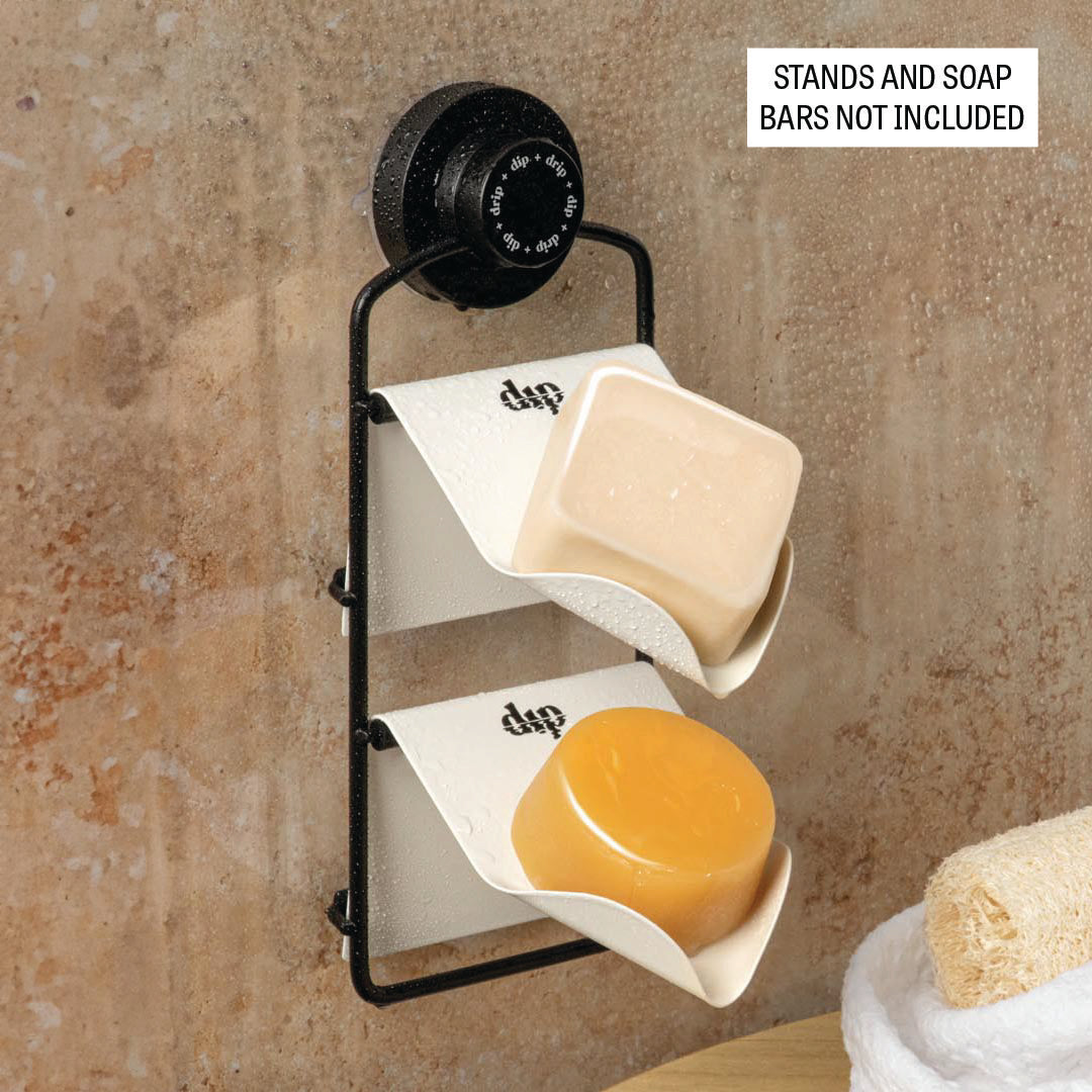 Wall-mounted soap holder with two soap bars on a textured wall background