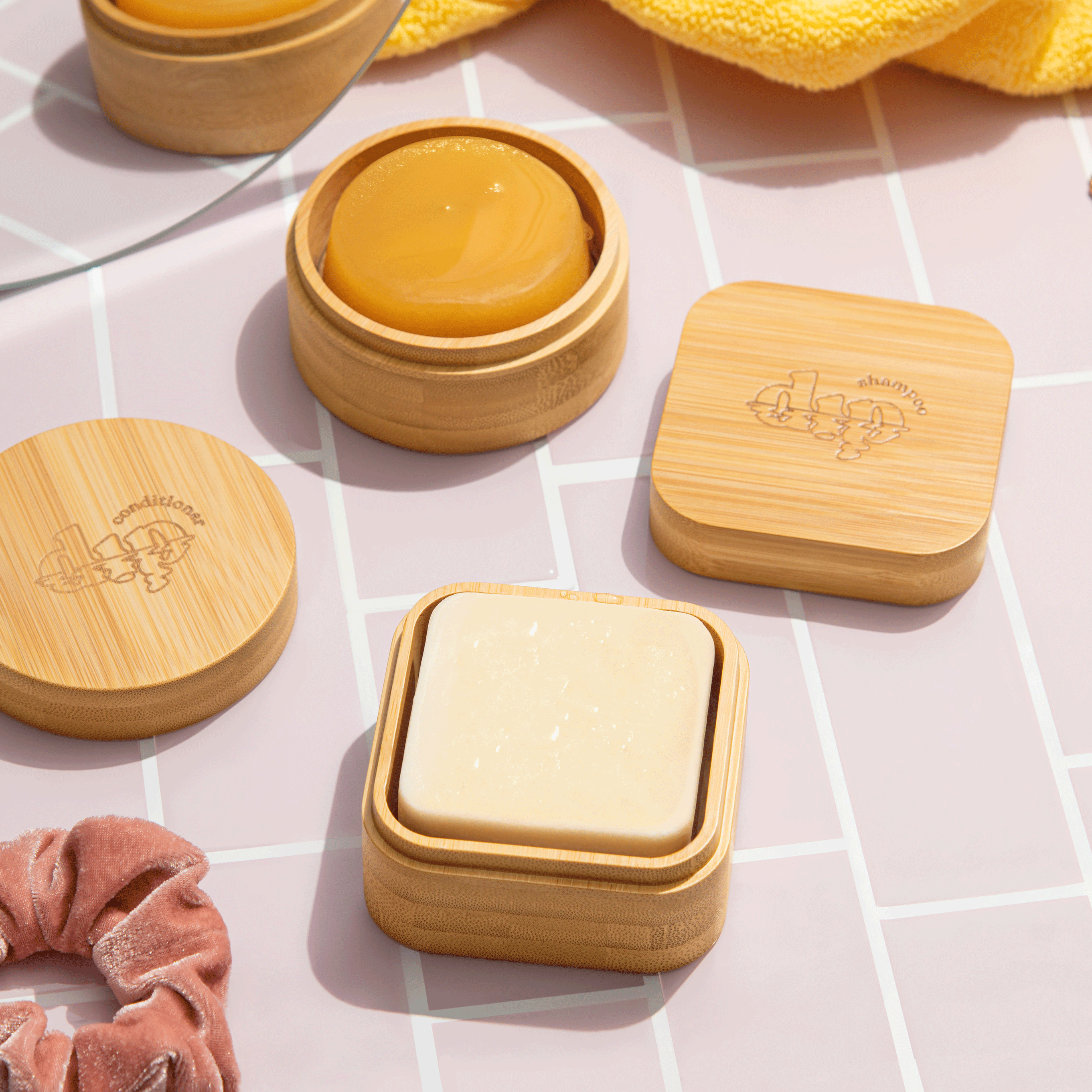 Bamboo containers with yellow and white bars of soap on a grid background