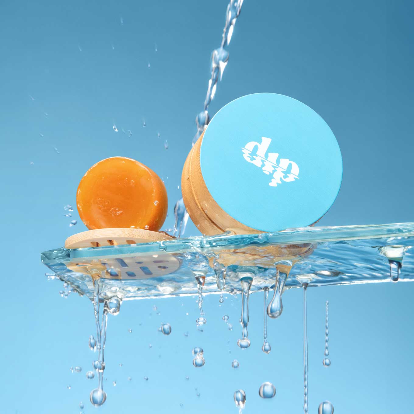 Orange and banana with water droplets on a blue background, featuring the 'dip' brand.