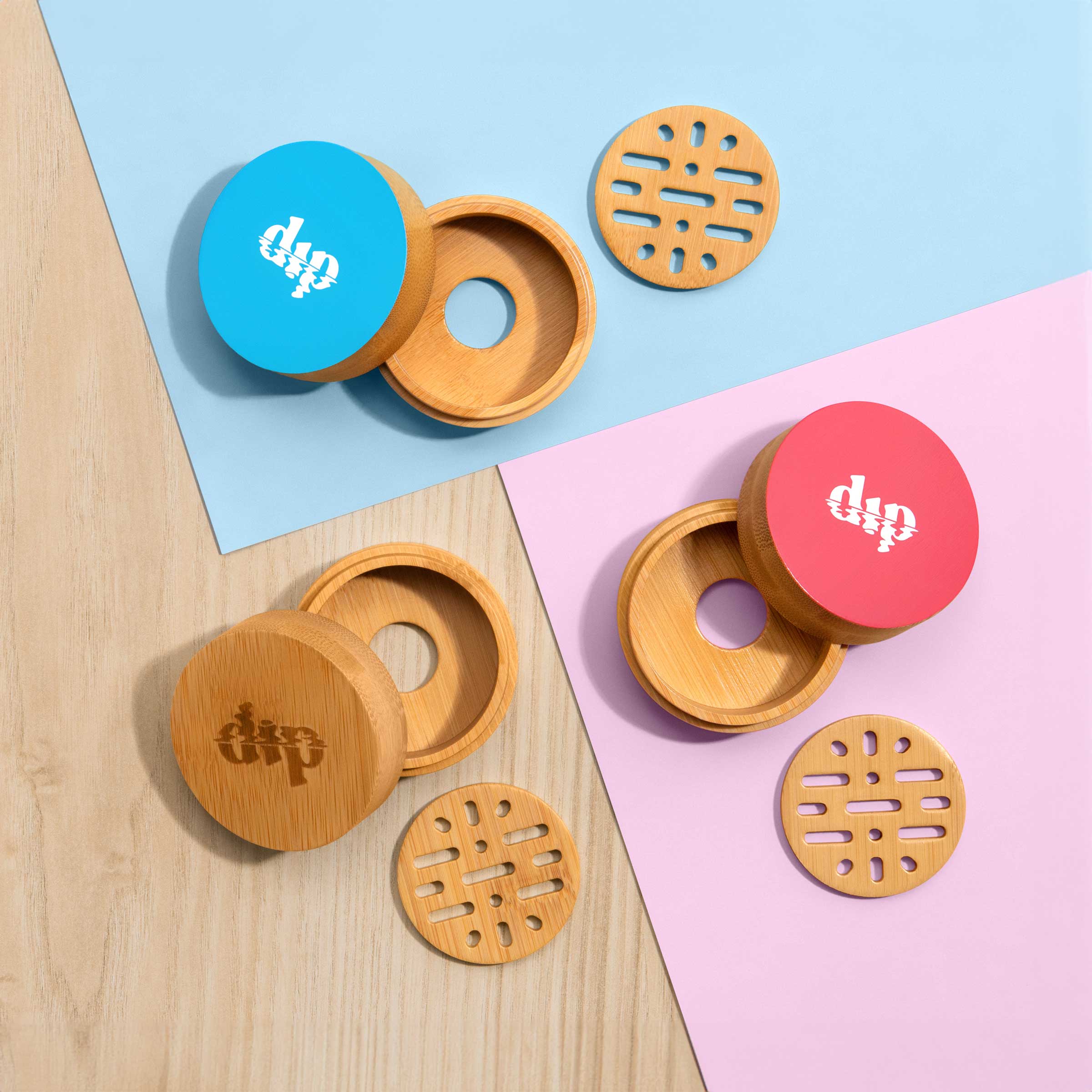 Wooden containers with circular lids on a colorful background