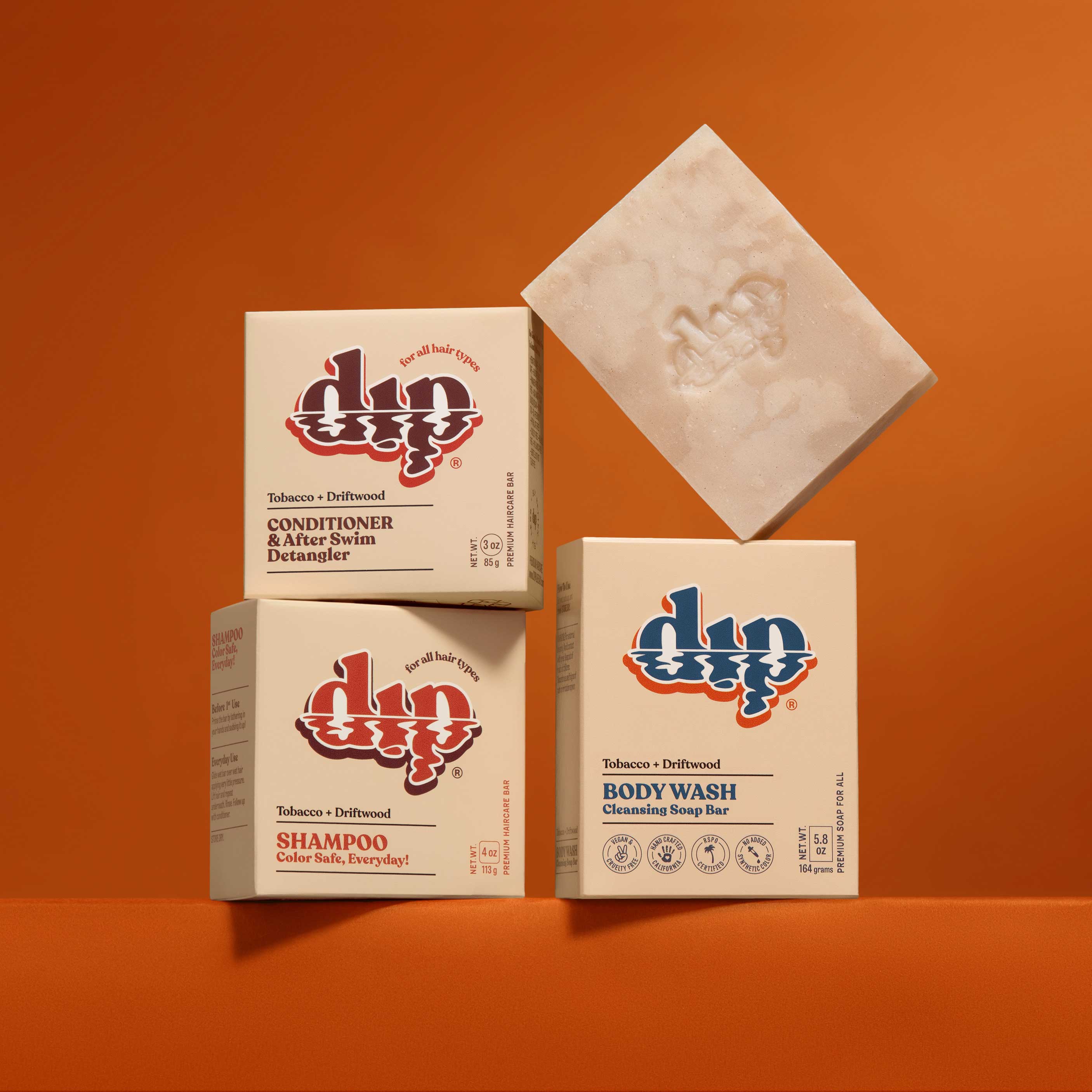 dip brand products including soap, shampoo, and conditioner on an orange background