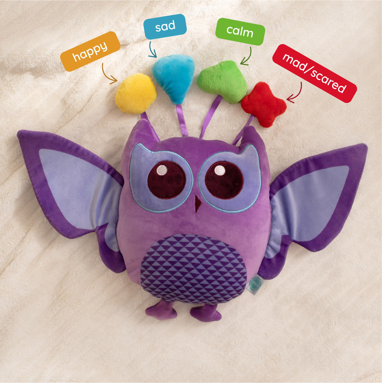 Purple owl plush toy with colorable face on a beige background