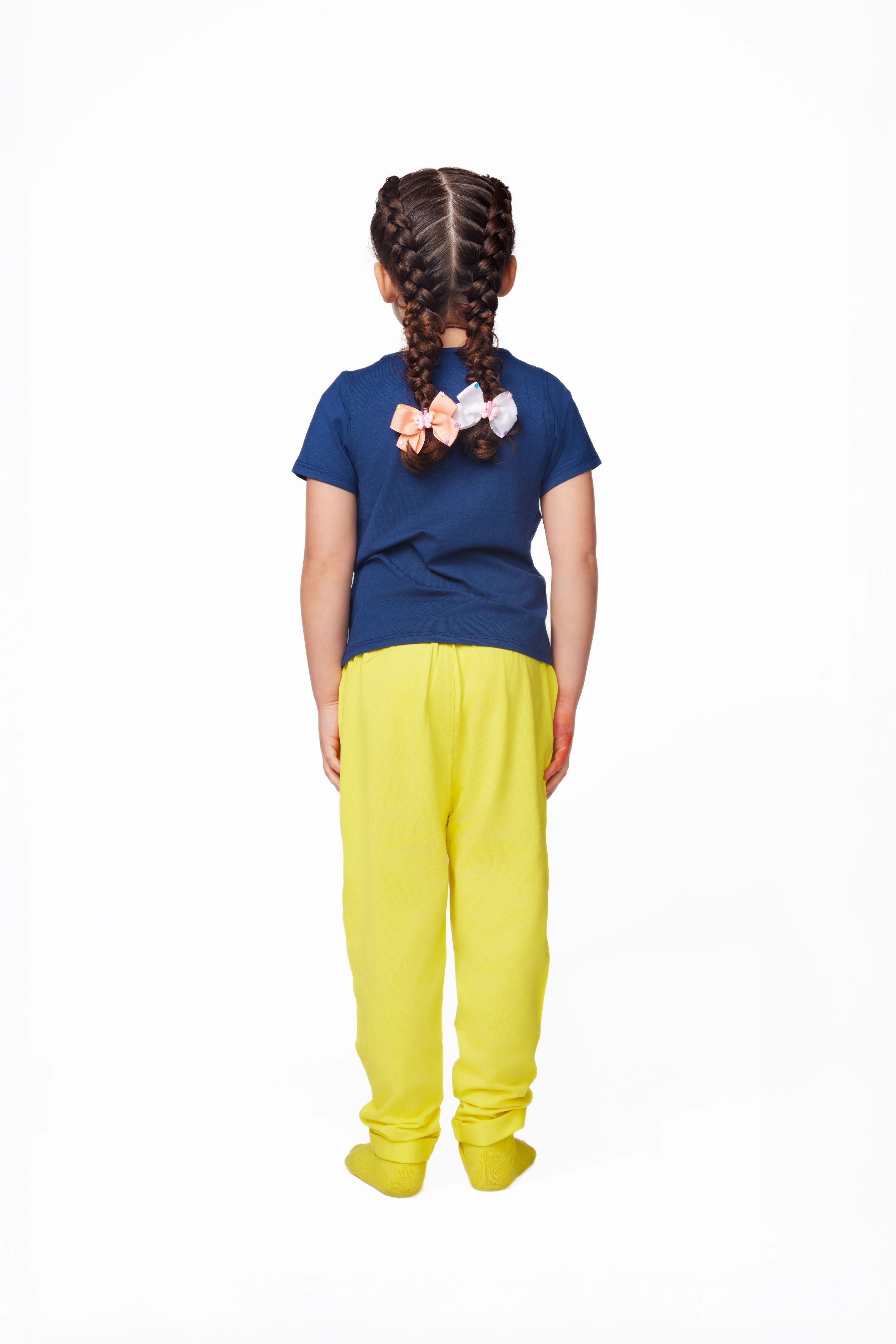 Person wearing a blue shirt and yellow pants on a white background