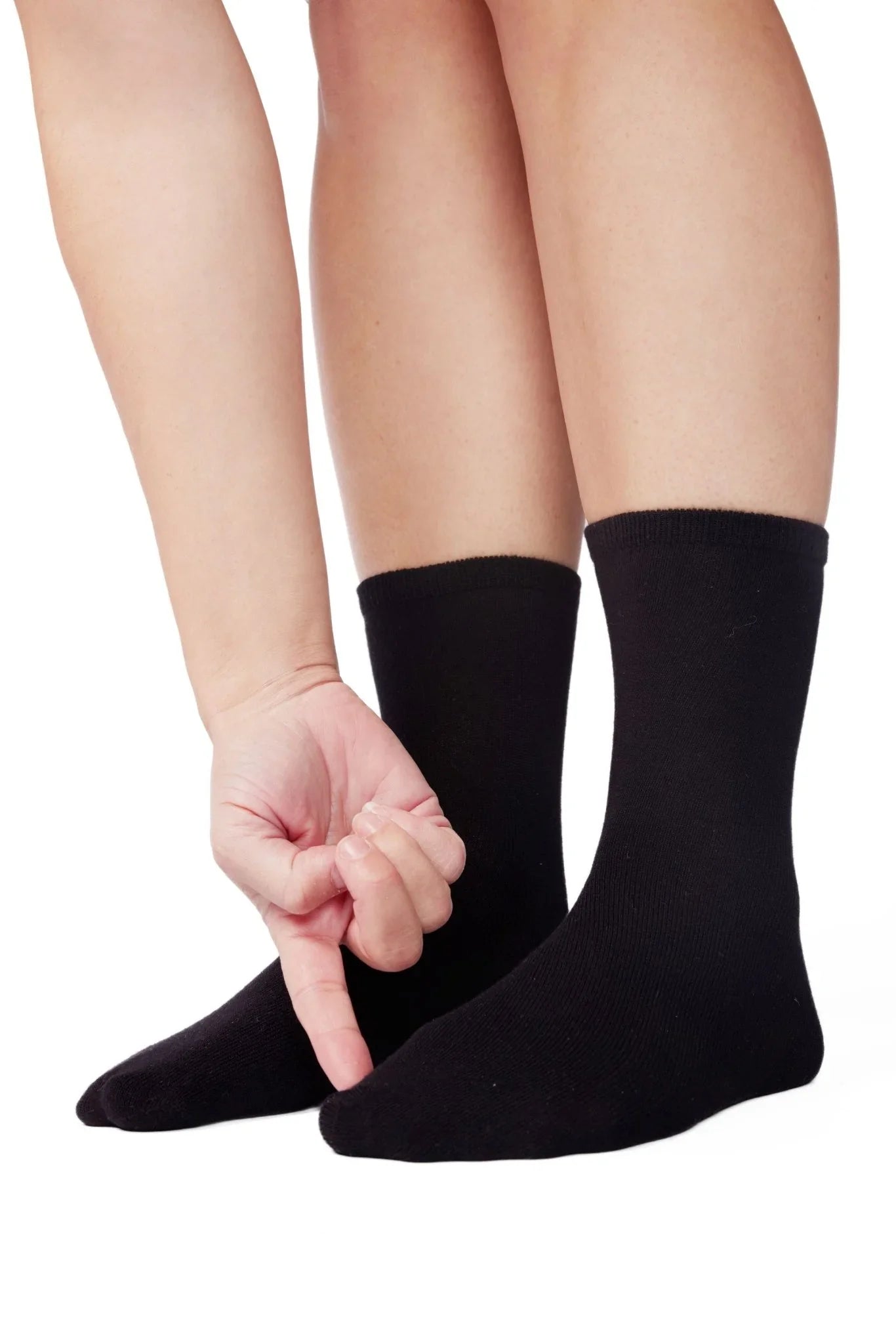 Person wearing black sensory-friendly socks on white background