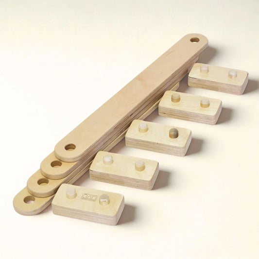 wooden children's balance beam parts, including planks and rectangular bases on light background