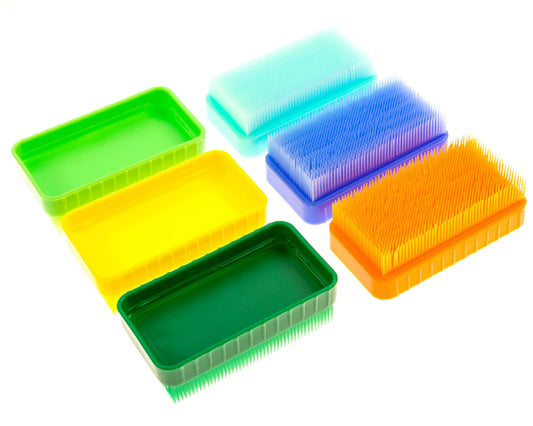 Colorful sensory brush boxes for kids, textured tactile stimulation tools on white background