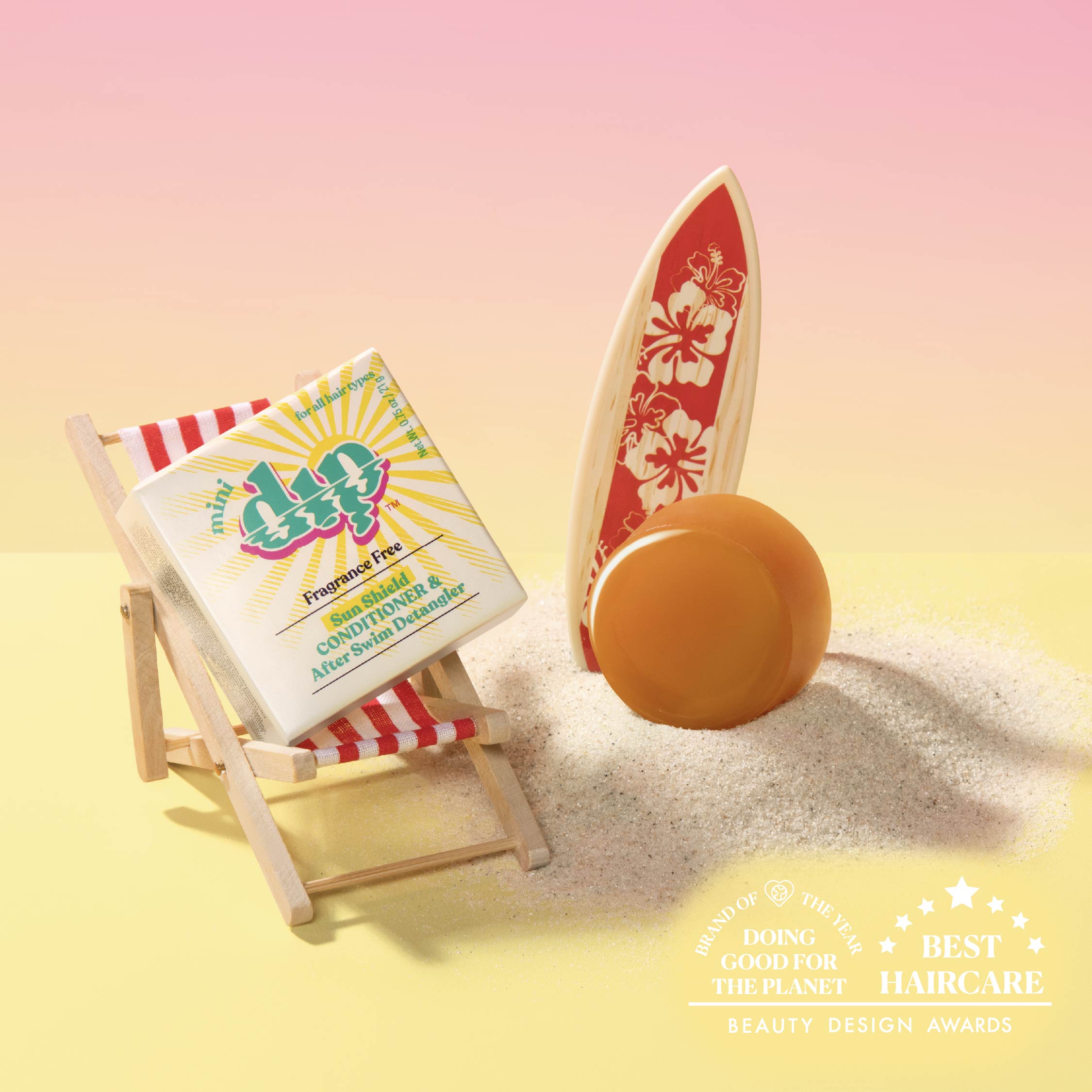 Bar of soap on a beach with a surfboard and deck chair, featuring a brand logo.