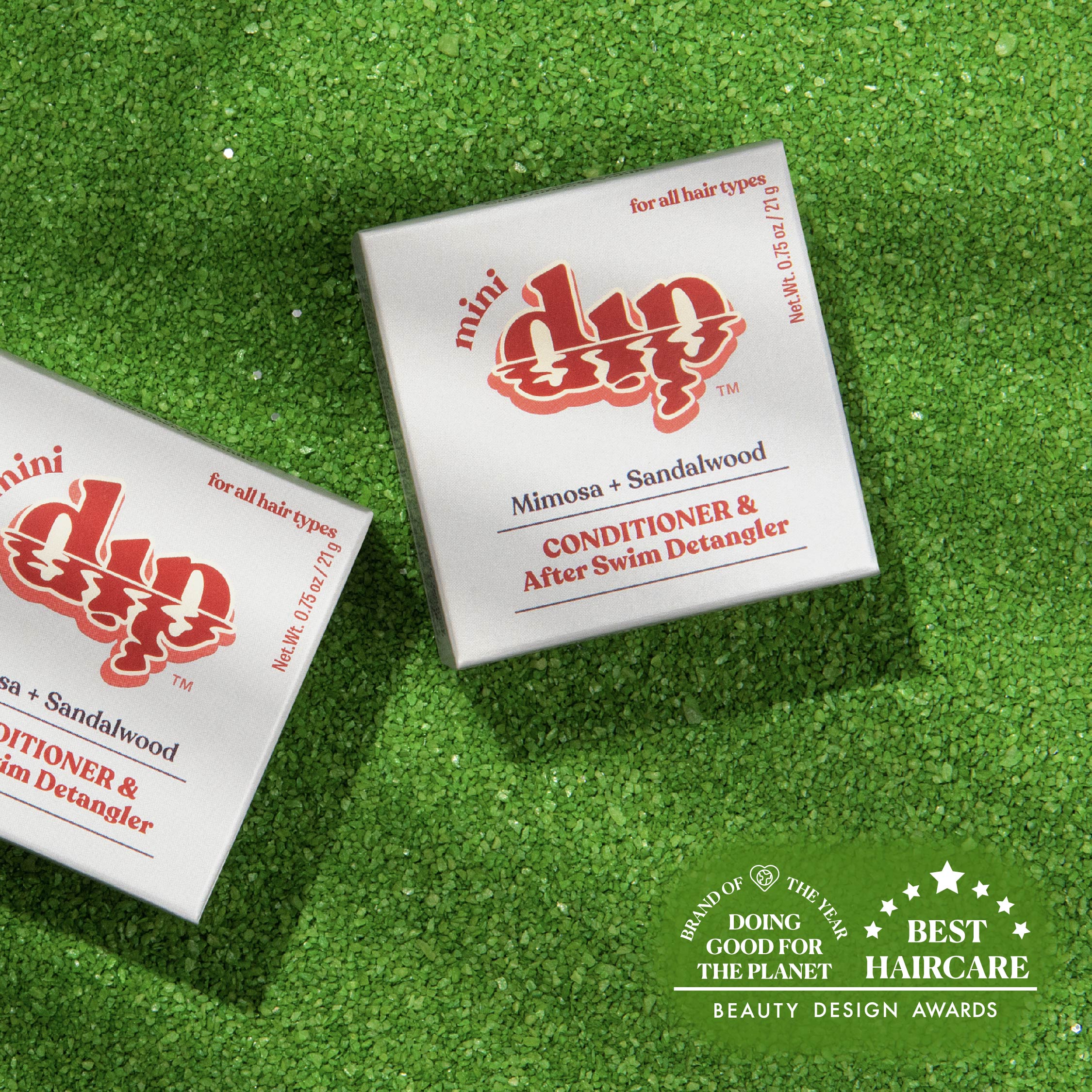 Two boxes of 'my dip' conditioner and after swim detangler on a green textured background with awards text.