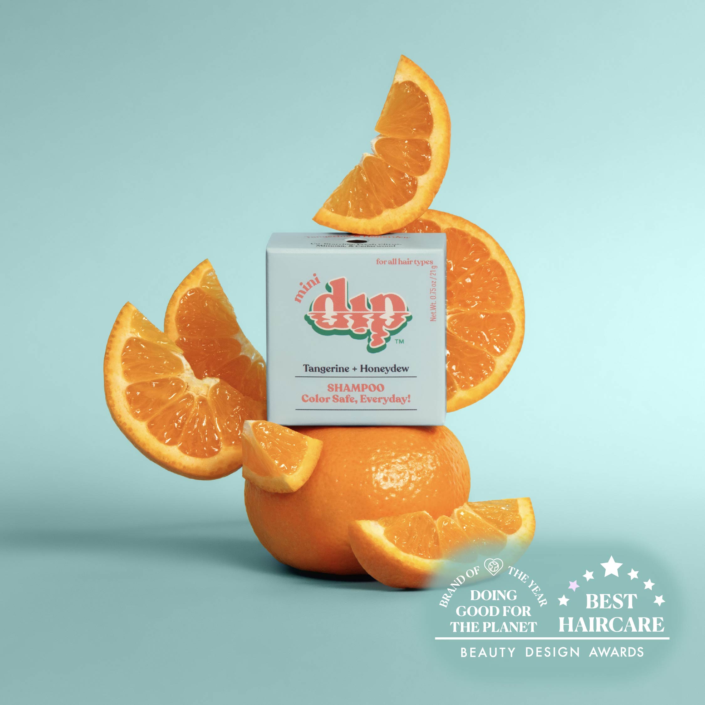 Dip shampoo box surrounded by orange slices on a light blue background