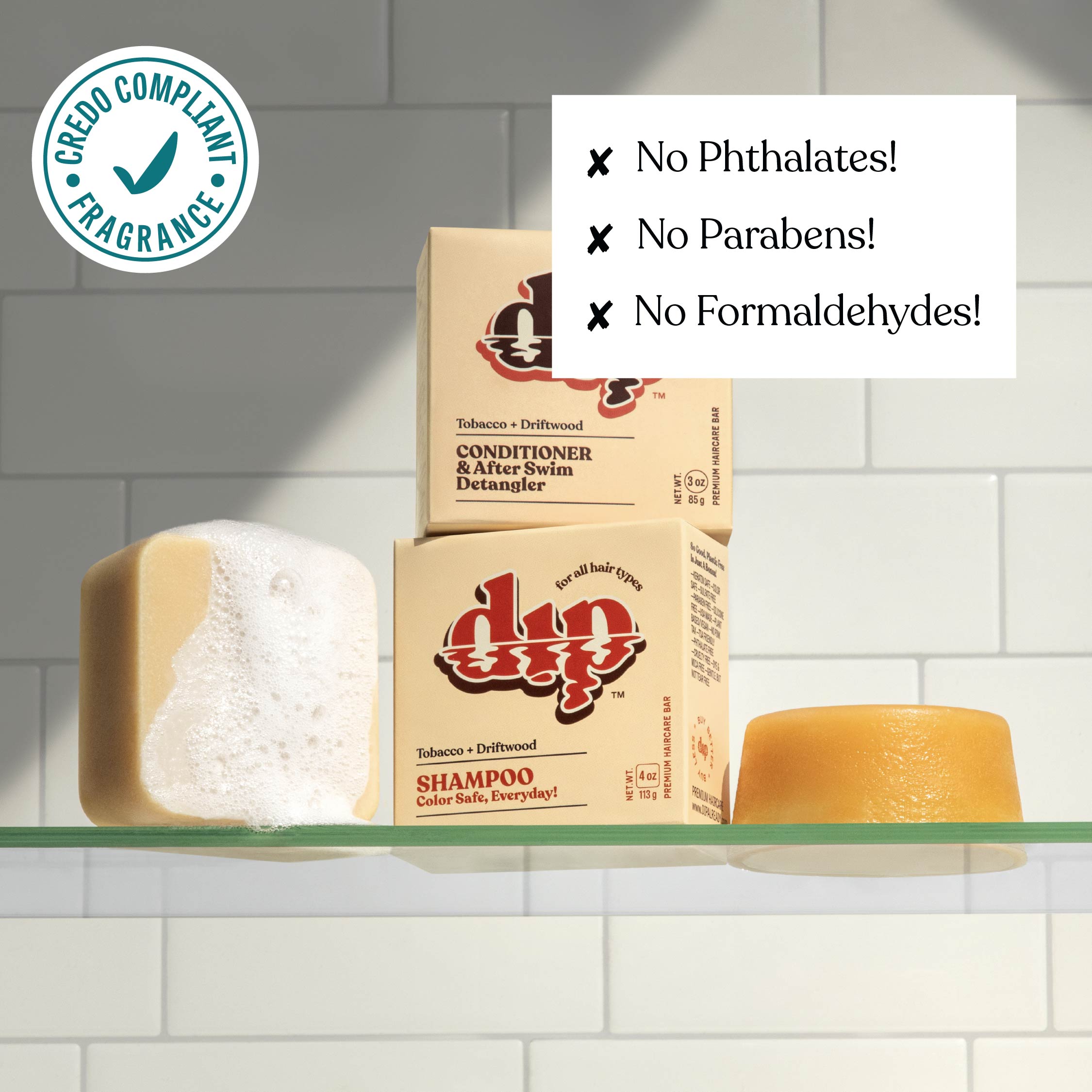 Shampoo bars and boxes on a shelf with green label and text about product ingredients.