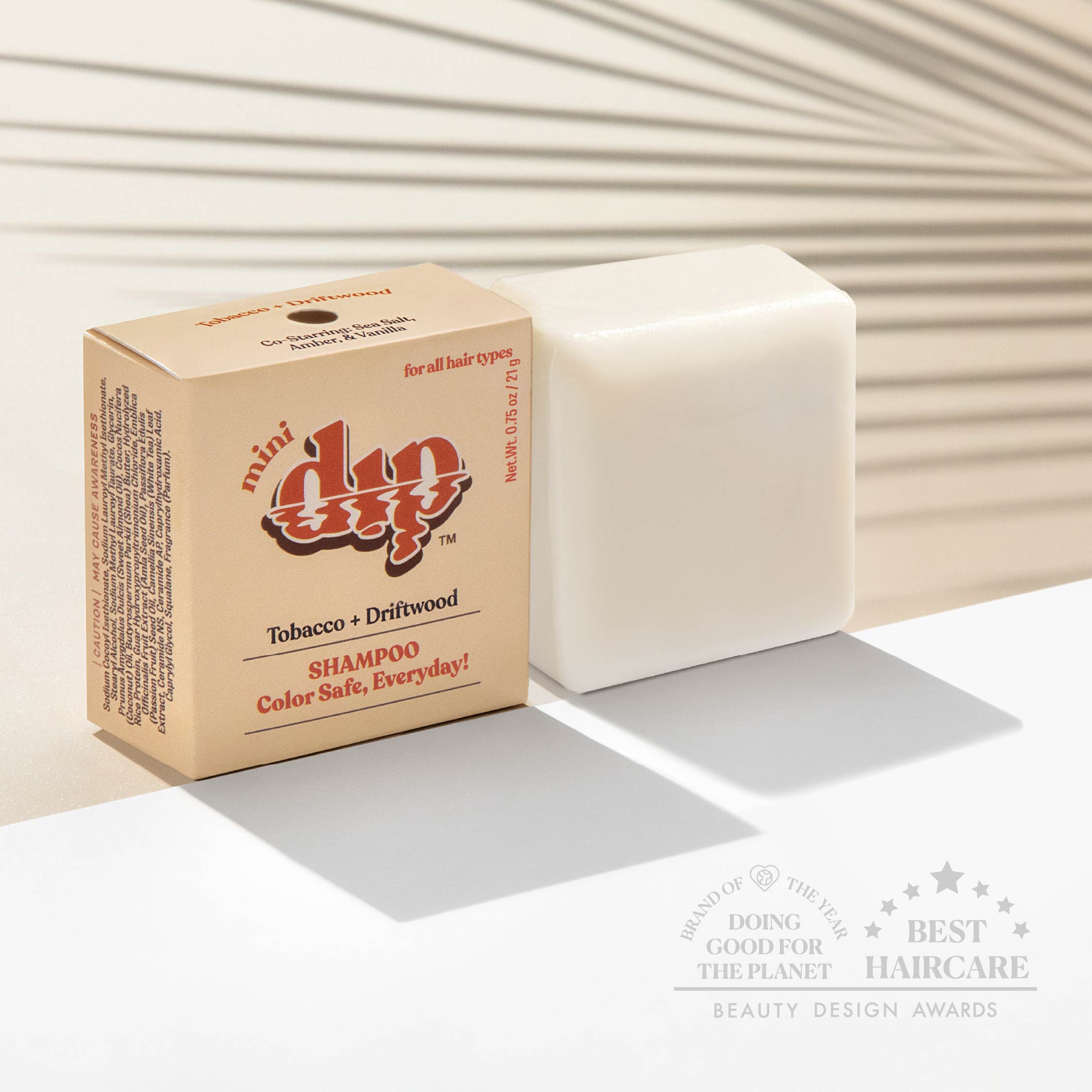 Bar of soap next to its packaging with 'dip' branding on a neutral background