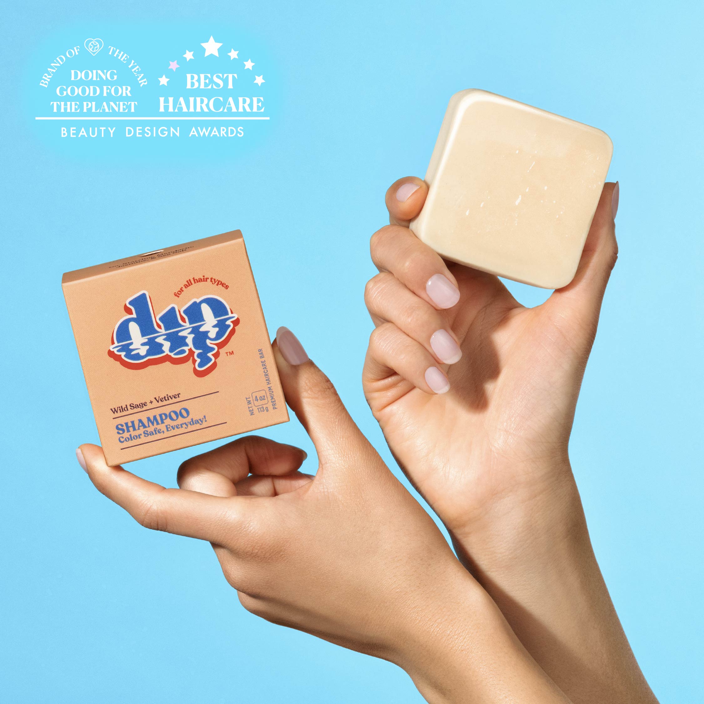 Hands holding a bar of soap and a box labeled 'dip' against a blue background with awards text.