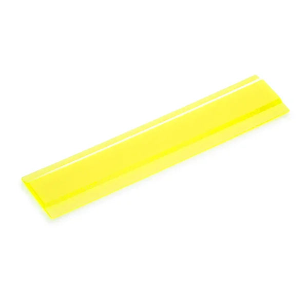 Yellow tinted reading guide strip for dyslexia or visual stress, angled on white background
