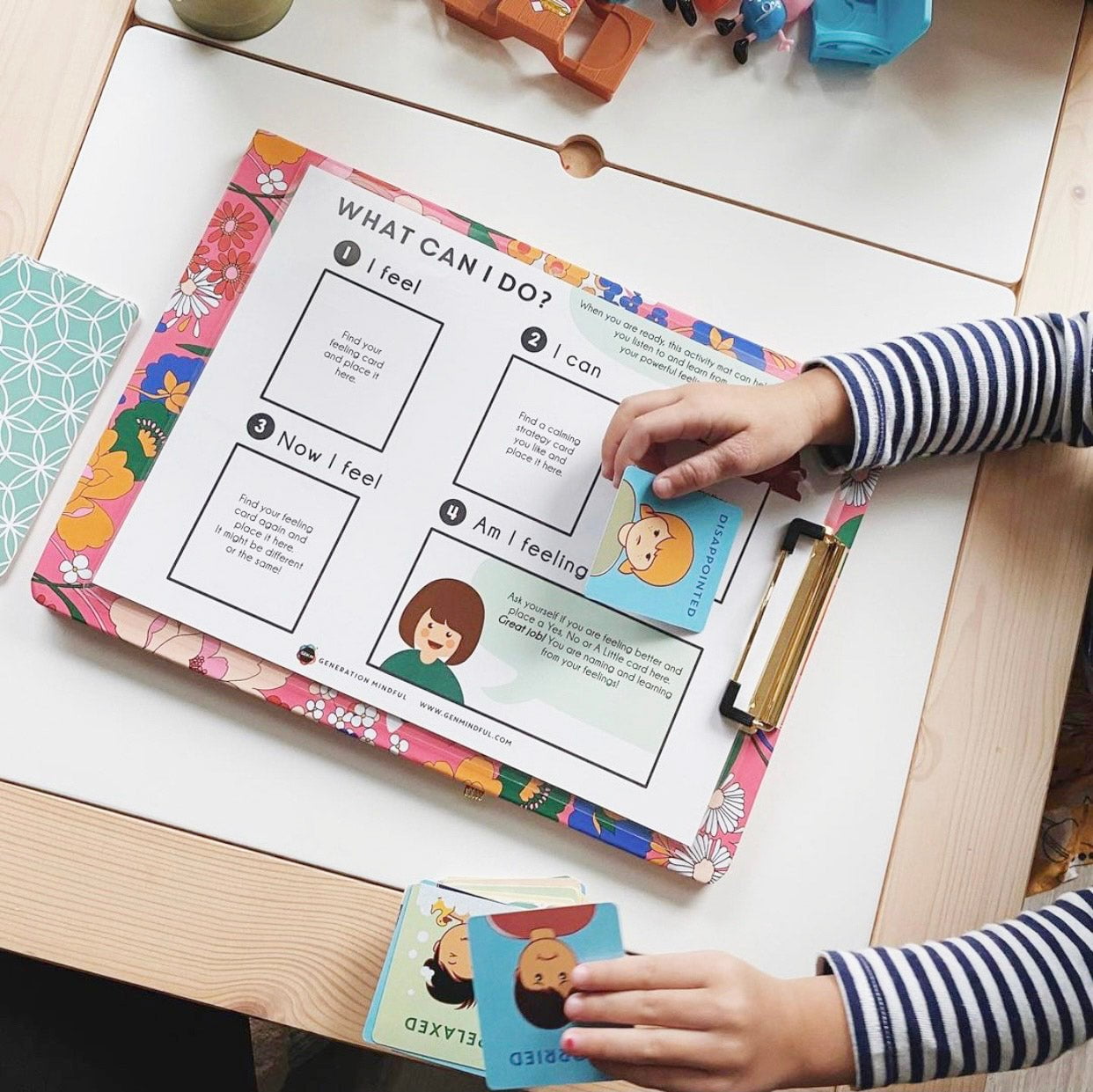 Child interacting with educational materials on a table