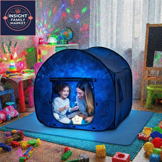 Parent and child in dark blue tent with galaxy design in a playroom