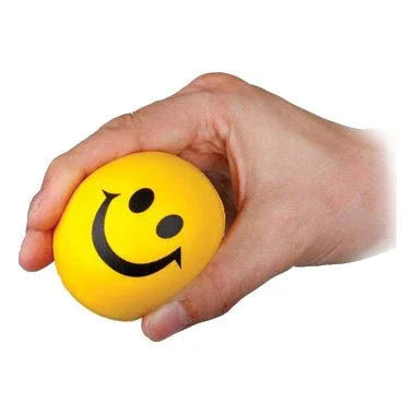 Hand squeezing a yellow smiley face stress ball, sensory fidget tool for focus and relief