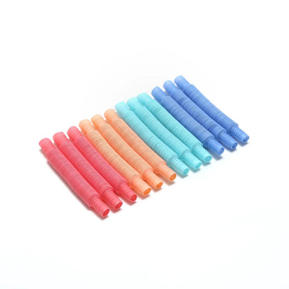Colorful sensory pop tube fidget toys arranged on a white background