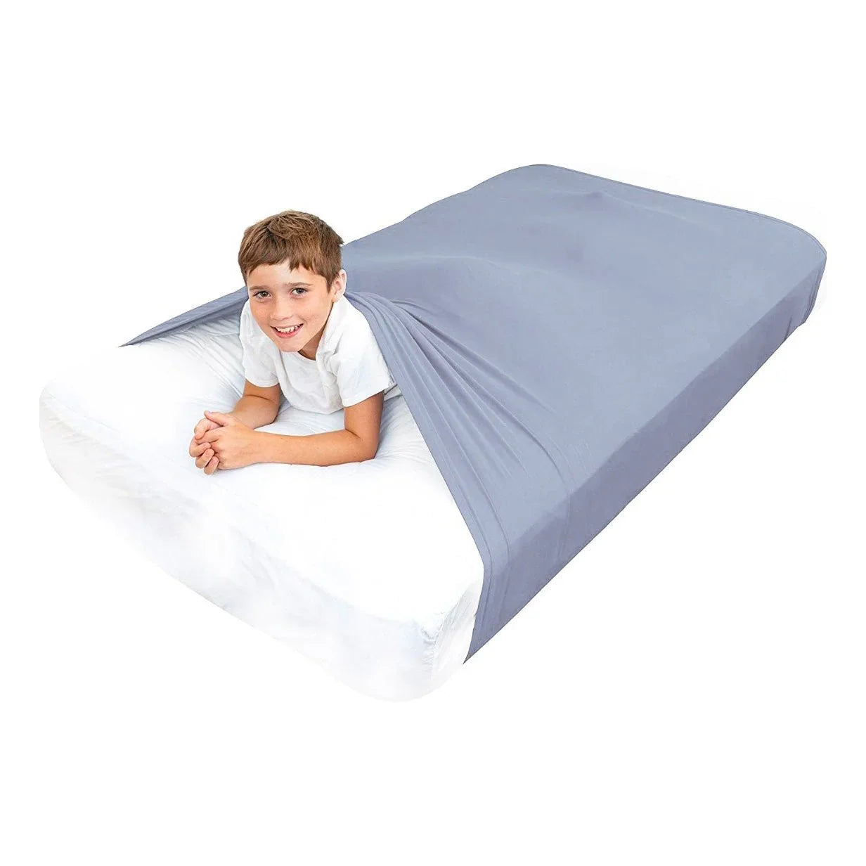 Smiling boy in white shirt using a gray sensory compression bedsheet for kids on a mattress