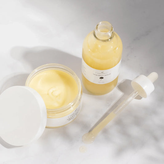 True Belly Serum and nourishing balm with dropper on a white surface, wellness skincare products