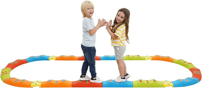 Two children playing on a colorful sensory balance beam obstacle course