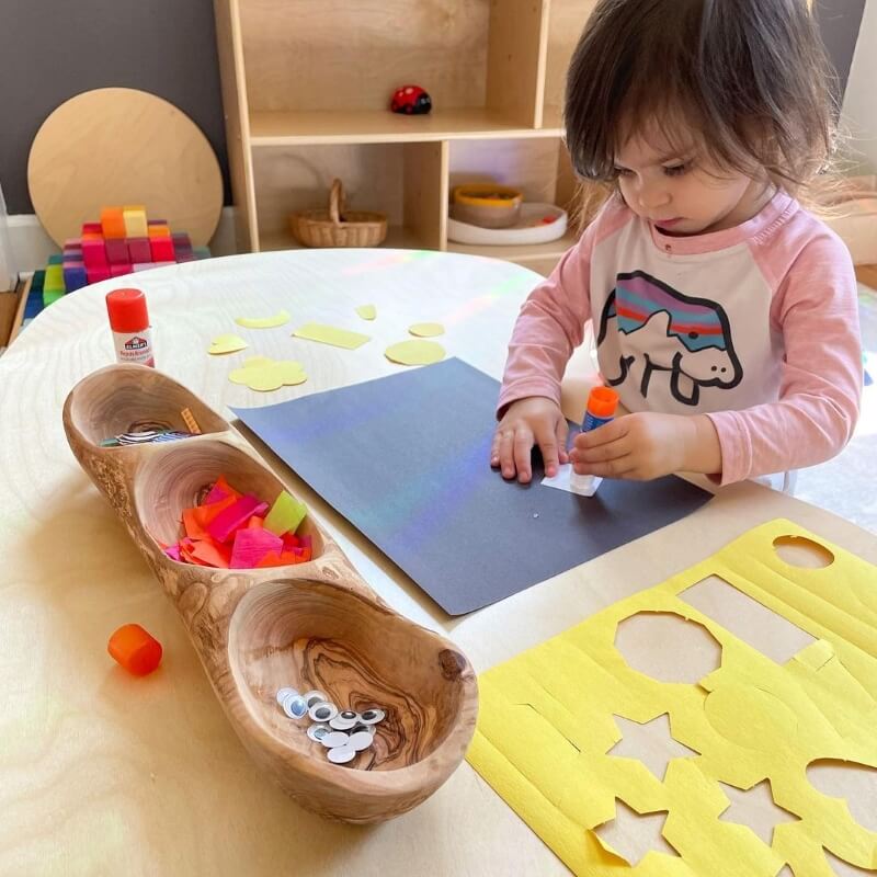Child playing with wooden toys at a table
