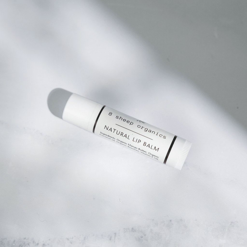 Lip balm tube labeled 'B sheep organics' on a light gray background
