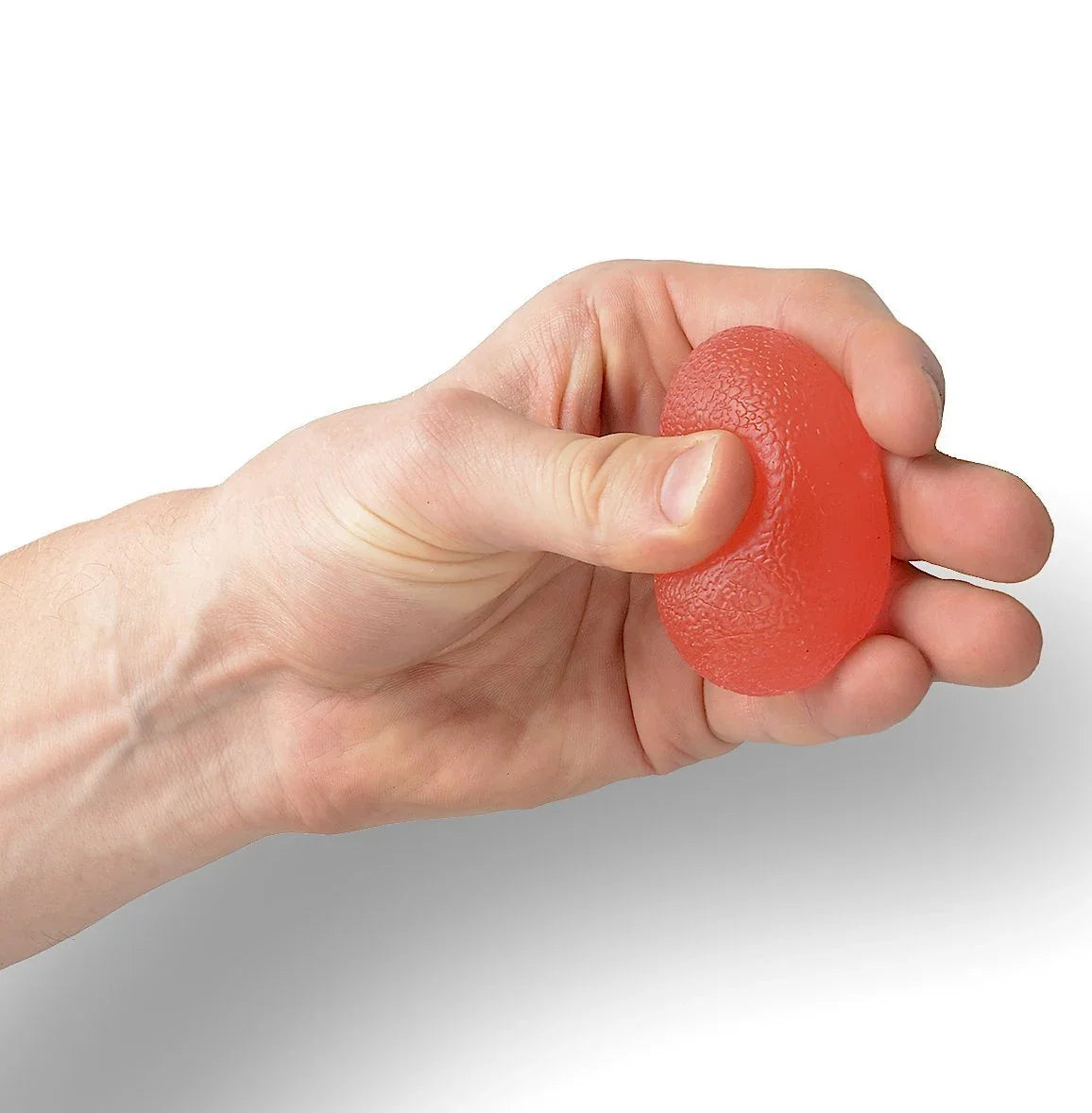 Hand squeezing a red textured sensory stress ball for fidget and focus support