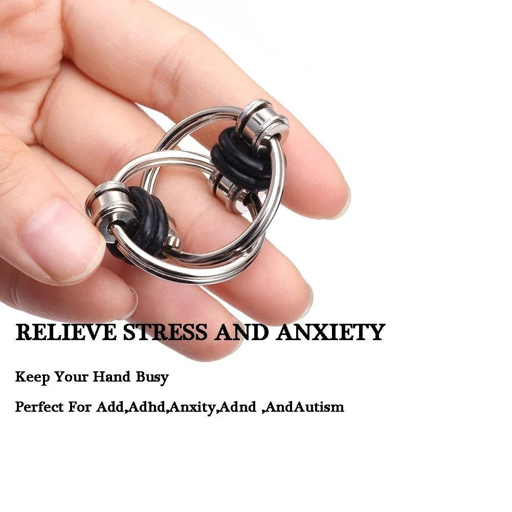 Hand holding a metal fidget toy with text promoting stress relief and sensory support
