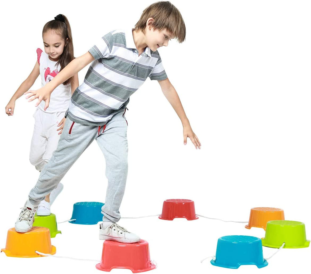 Two children playing with colorful stepping stones on a white background