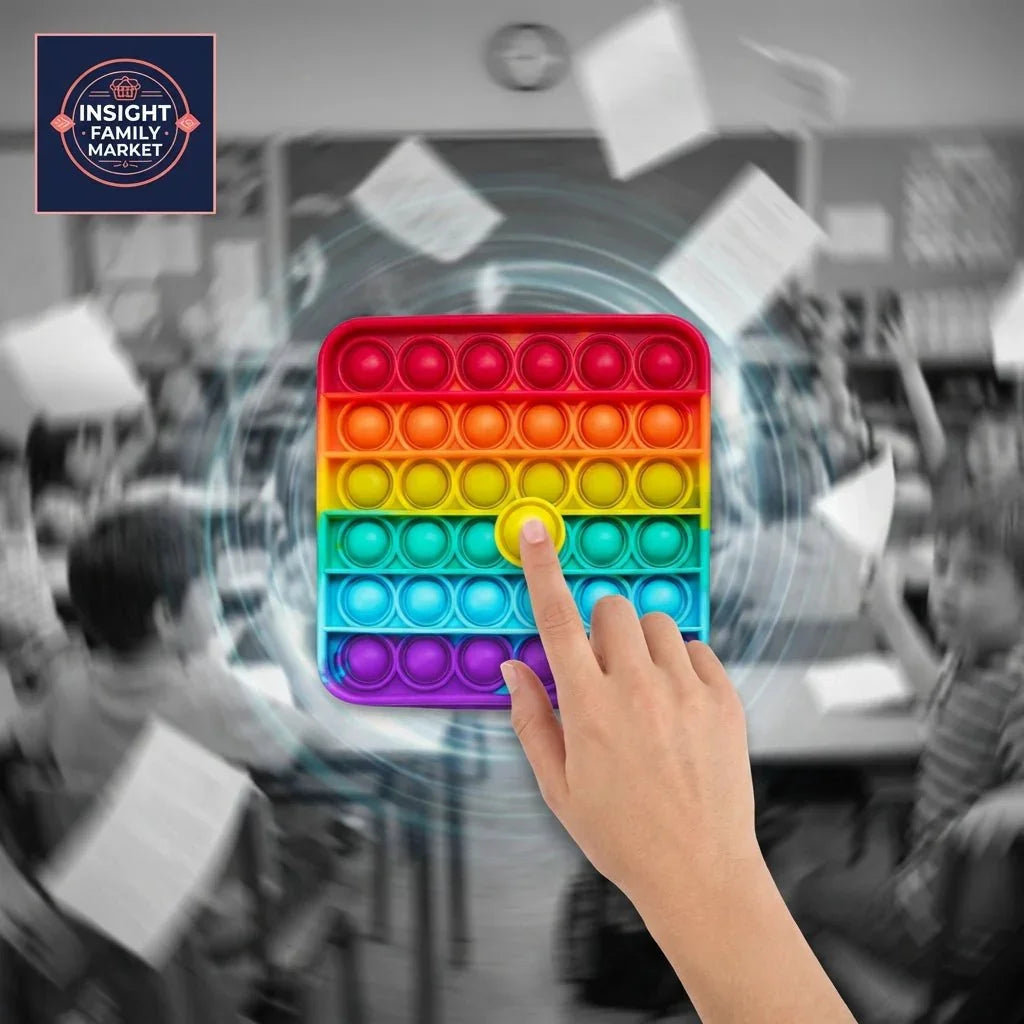 Hand pressing rainbow fidget popper in busy classroom, sensory tool for neurodiverse kids
