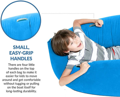 Child sitting on a large blue sensory bean bag chair with easy-grip handles, for comfort support.