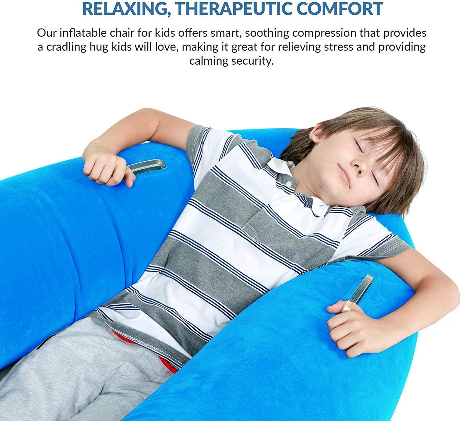 Child relaxing in a blue inflatable sensory compression chair for calming therapy