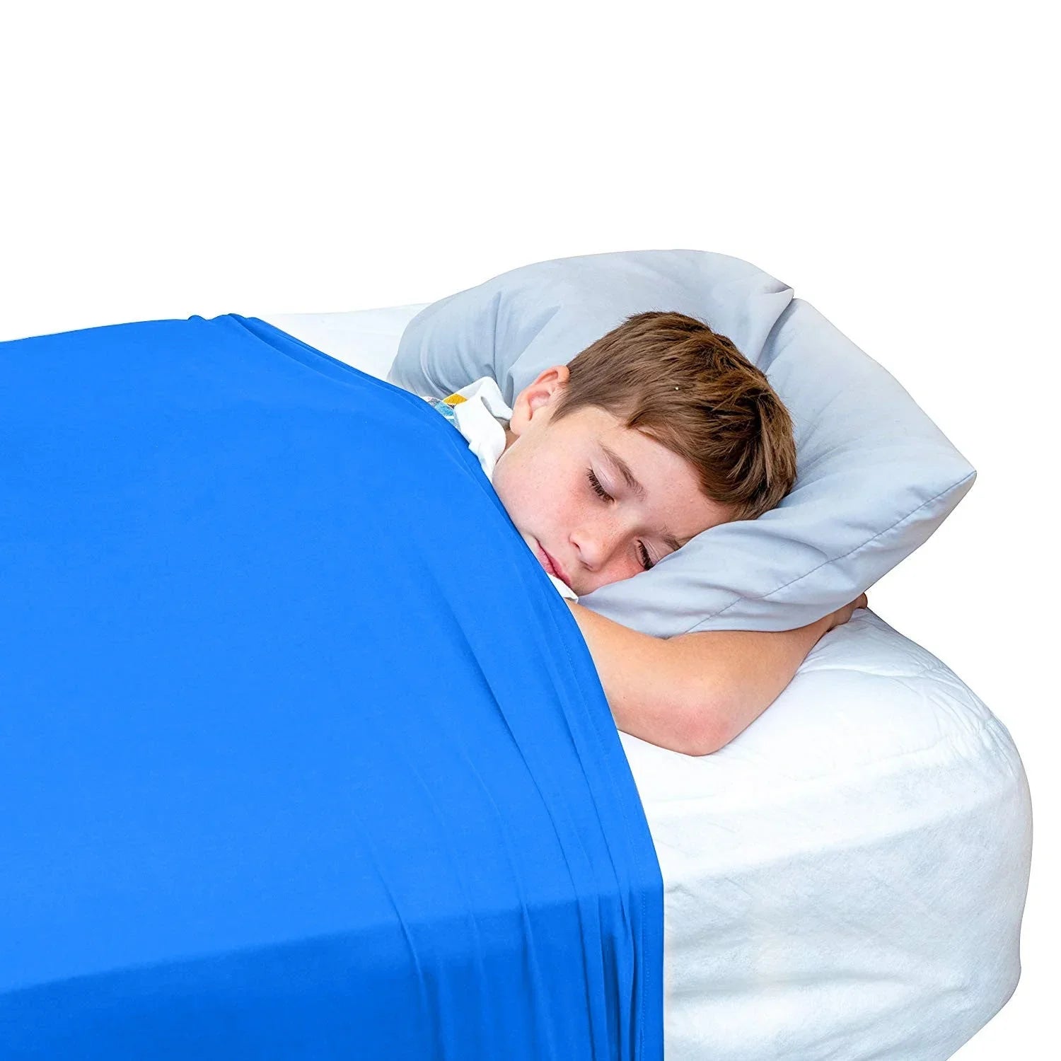 Child sleeping under blue sensory compression blanket on white bed with gray pillow