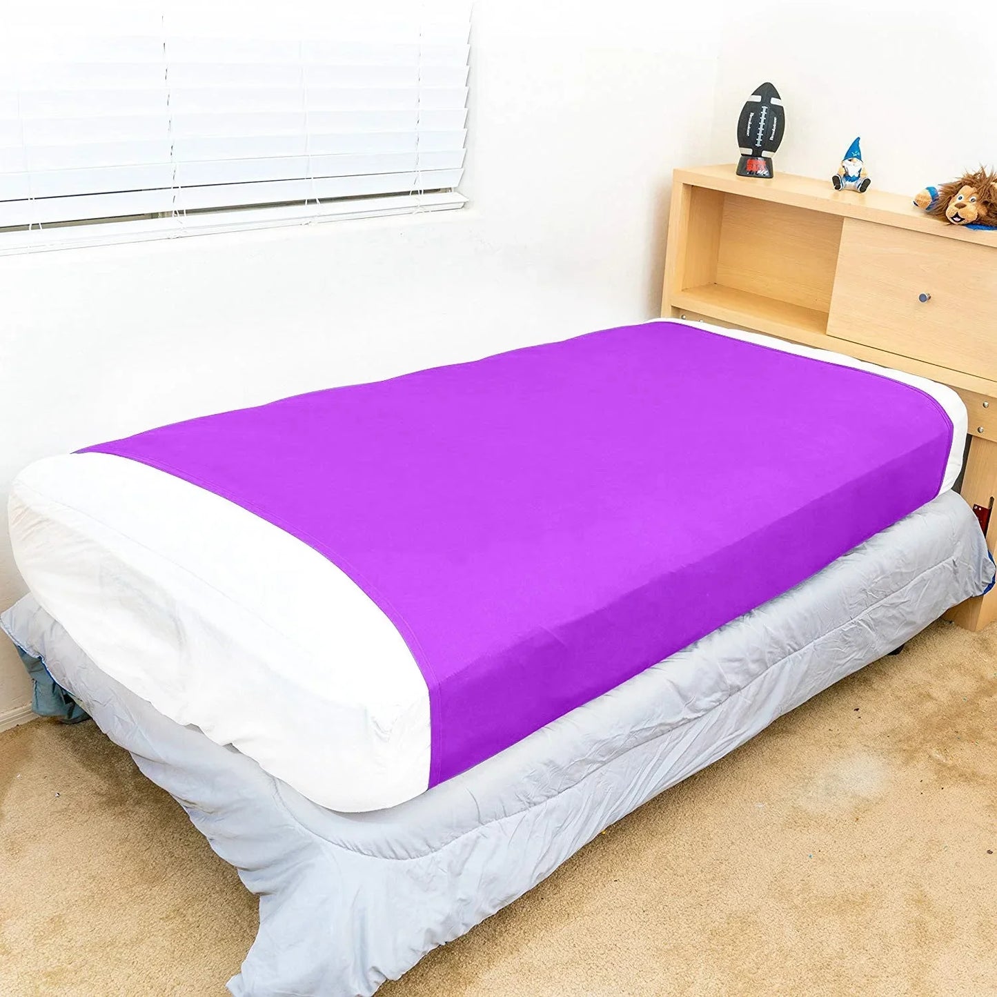 Purple sensory compression sheet on twin bed in a child's bedroom, sensory-friendly bedding