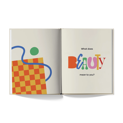 Open book with colorful abstract art, checkerboard pattern, and text 'What does BEAUTY mean to you?'