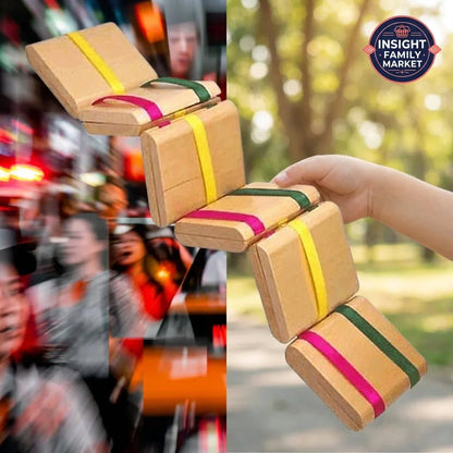 Hand holding a wooden sensory fidget toy outdoors, blurred crowd in background, sensory support