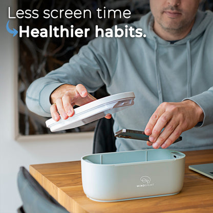 Person using a device with text 'Less screen time, Healthier habits.' and a MindSight container on a desk.