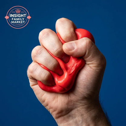 Hand squeezing red sensory stress putty against blue background, sensory tool for focus
