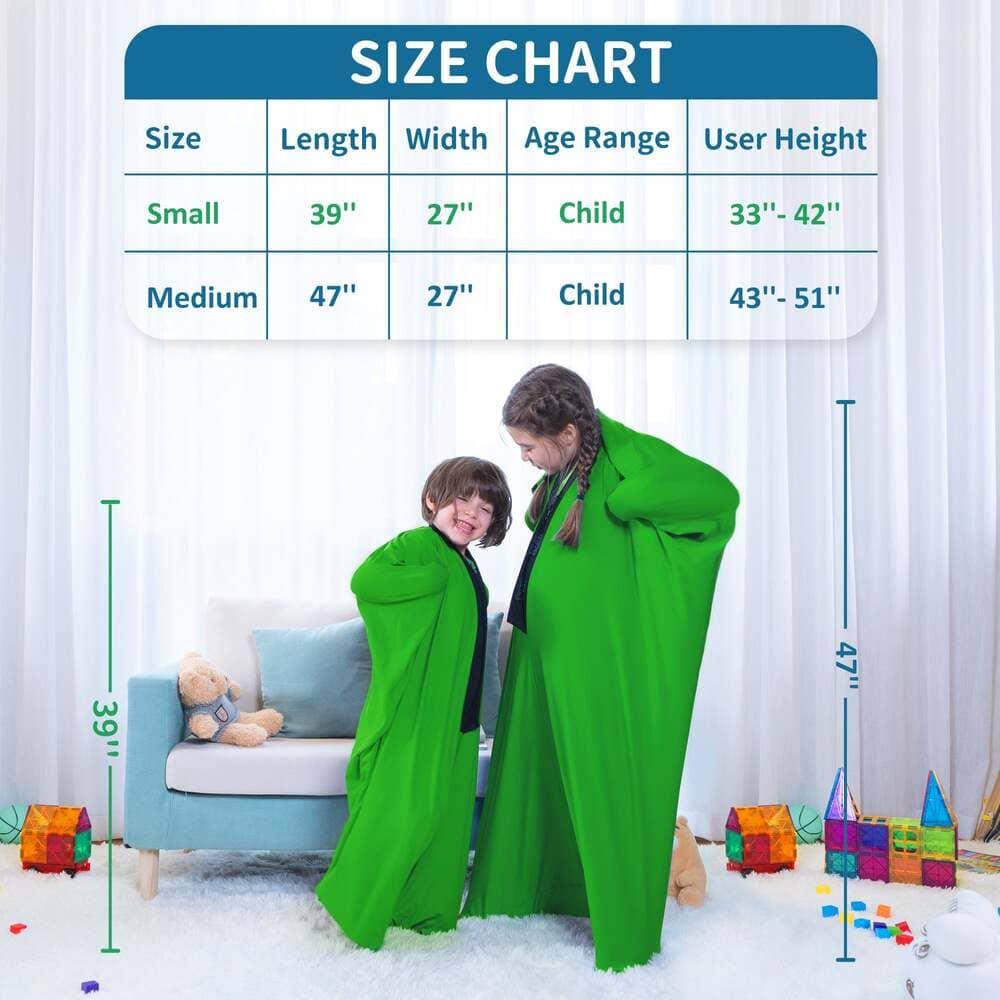 Two children in green sensory compression suits stand in a playroom with a size chart above.