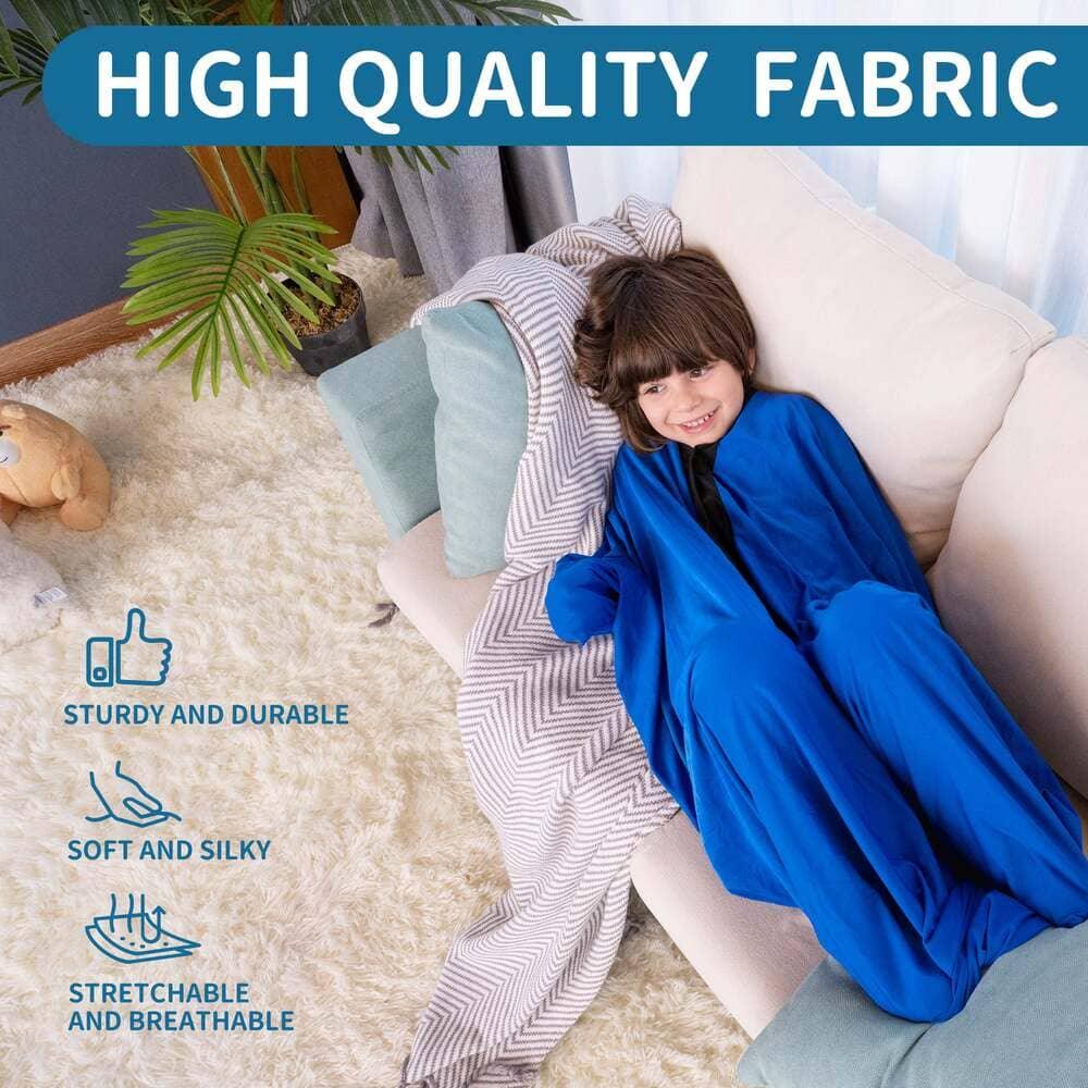 Smiling child in blue sensory-friendly stretch blanket on a cozy couch, soft fabric benefits shown
