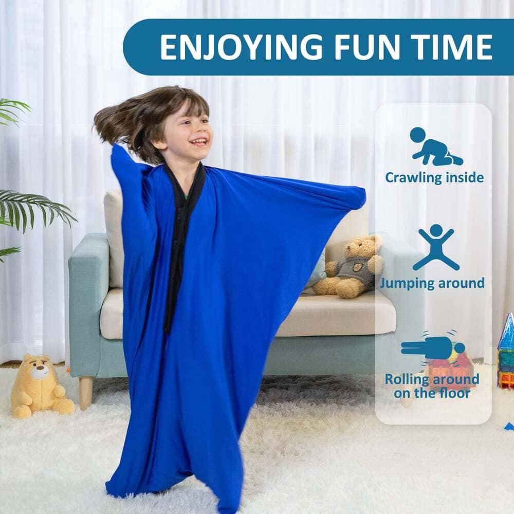 Child smiling in a blue sensory body sock plays in a living room, promoting sensory activities.