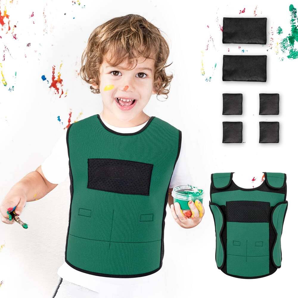 Child wearing a green art smock with paint splashes and additional smocks displayed.