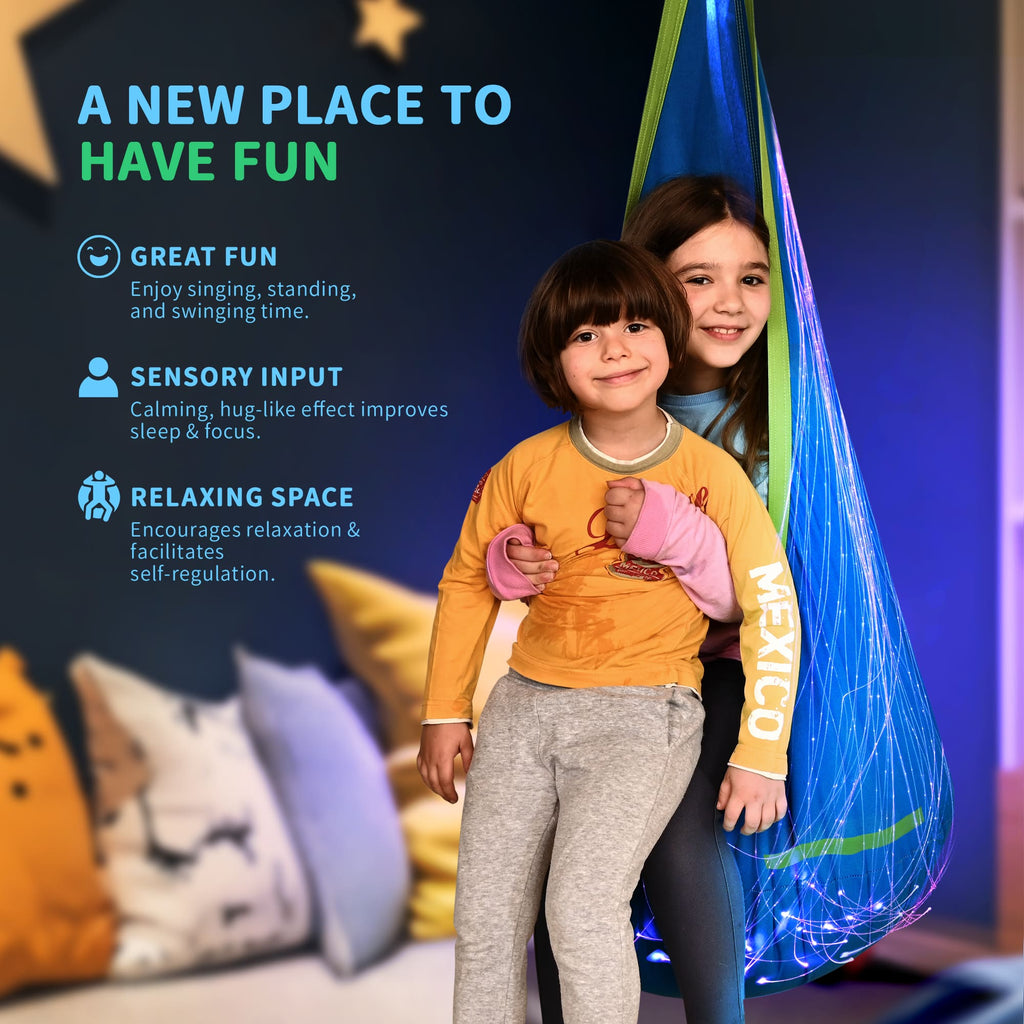 Children playing with a colorful hanging toy in a room with pillows and a dark wall.